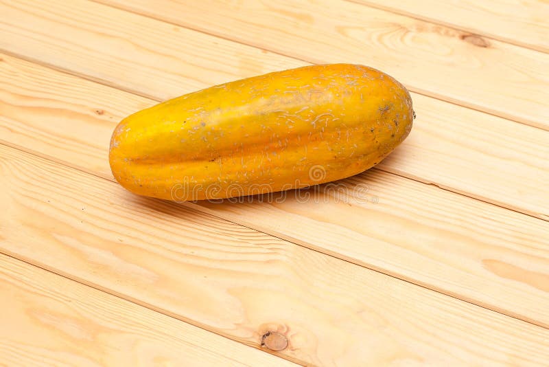 A large yellow cucumber on a white background. An overgrown cucumber. Food products. A large yellow cucumber on a white background. An overgrown cucumber. Food products.