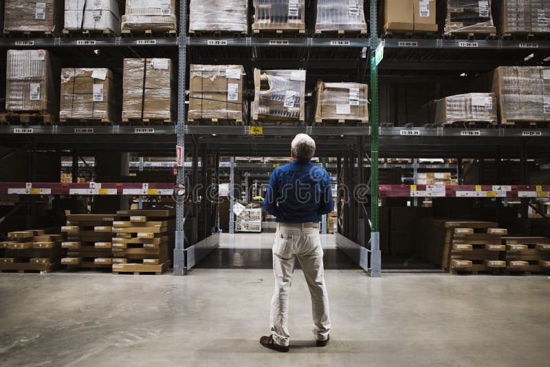 A Caucasian man is checking stock inventory. A Caucasian man is checking stock inventory