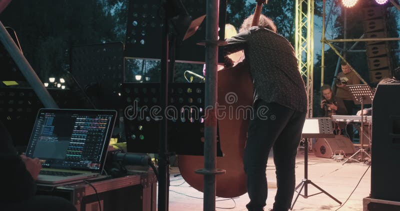 Un homme caucasien à un concert joue du jazz et du blues sur une contrebasse sans arc