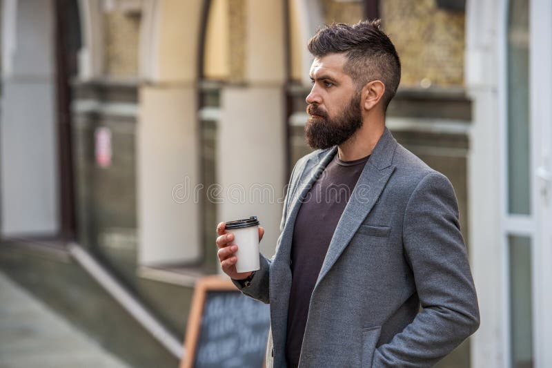 Un homme à la tête qui a du café dans la rue de la ville. Homme beau dans la rue tenant une tasse de café. Séparation du mode de v photos libres de droits