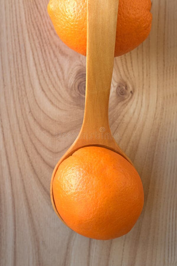 Fresh, healthy orange on a laminate background Two oranges, top view. Copy space Wooden spoon. Fresh, healthy orange on a laminate background Two oranges, top view. Copy space Wooden spoon
