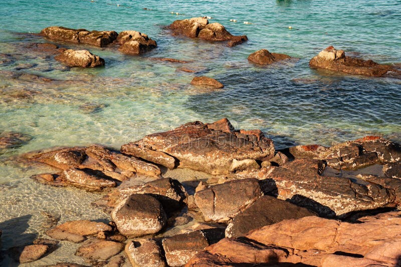 A tropical island with crystal clear seawater. rocks with millenniums mark the oceans and their waves at Long Beach Redang Islands, Malaysia. A tropical island with crystal clear seawater. rocks with millenniums mark the oceans and their waves at Long Beach Redang Islands, Malaysia