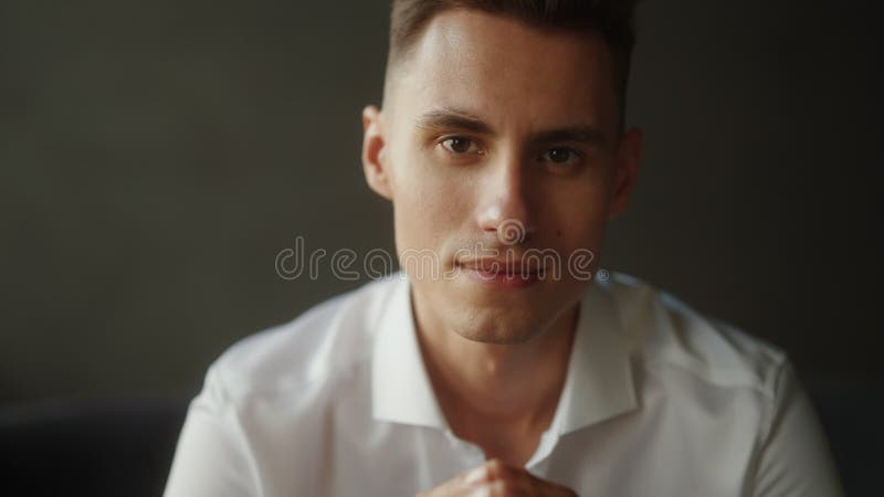 Un jeune homme confiant en chemise blanche, les mains tendues