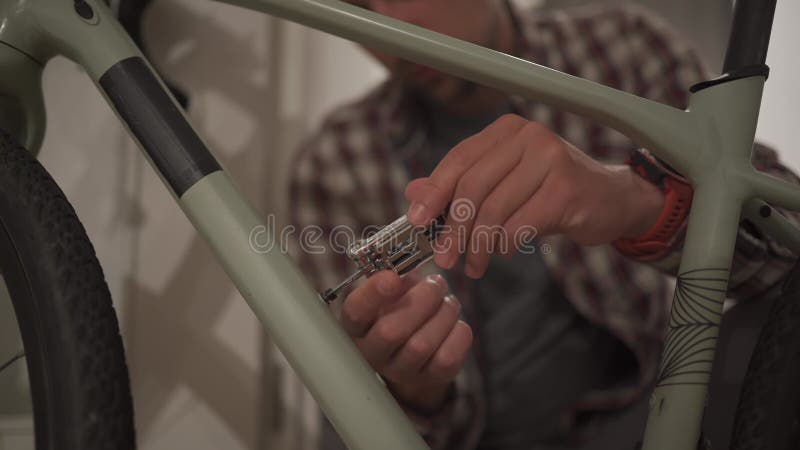 Un Jeune Homme Installe Un Accessoire De Vélo à La Maison Dans Un Studio.  Un Jeune Homme Met Un Vélo à La Maison. Fixation Mâle Clips Vidéos - Vidéo  du garage, gravier