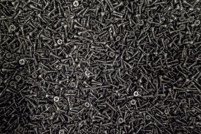 Un lío de tornillos negros clasificados imagen de archivo libre de regalías Un lío de tornillos negros clasificados imagen de archivo libre de regalías