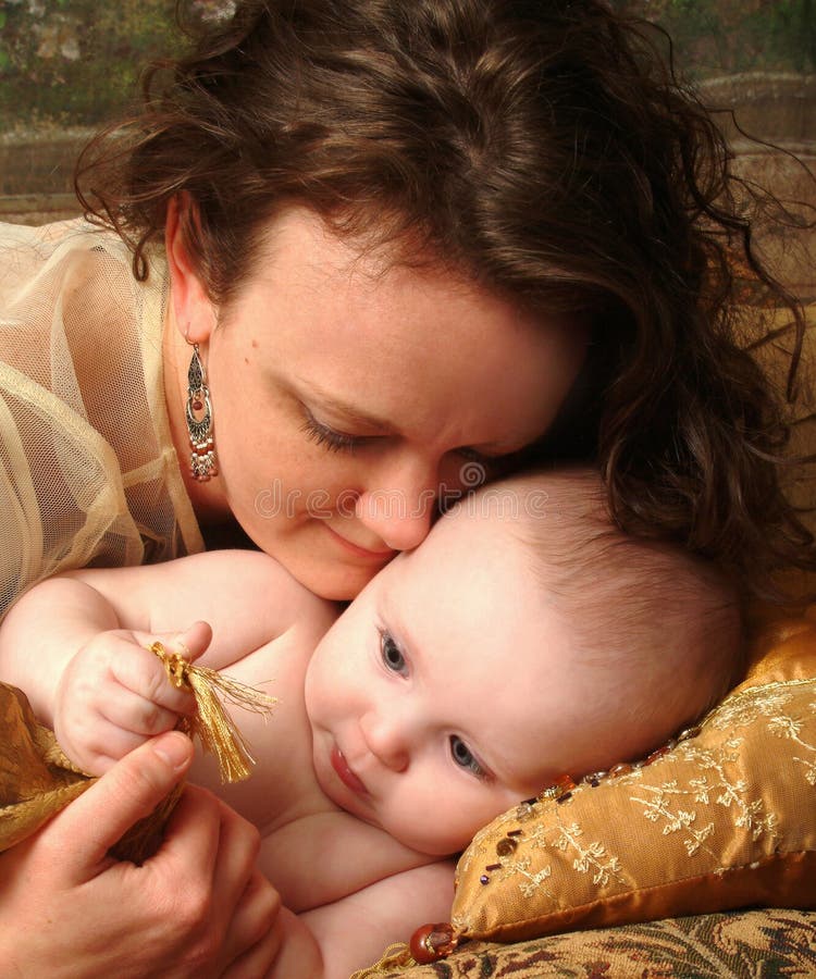 Loving mother observing her baby discovering the sense of touch. Loving mother observing her baby discovering the sense of touch