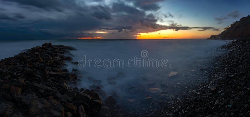 Panorama of three frames a general view of the rocky shore of the Black Sea coast after sunset, Anapa,  Russia. Panorama of three frames a general view of the rocky shore of the Black Sea coast after sunset, Anapa,  Russia