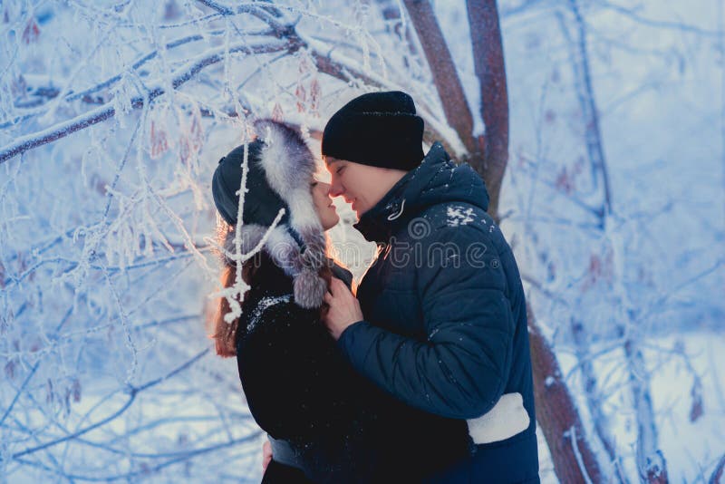 Un par cariñoso en un paseo del invierno Historia de amor de la nieve, magia del invierno Hombre y mujer en la calle escarchada E fotografía de archivo libre de regalías Un par cariñoso en un paseo del invierno Historia de amor de la nieve, magia del invierno Hombre y mujer en la calle escarchada E fotografía de archivo libre de regalías