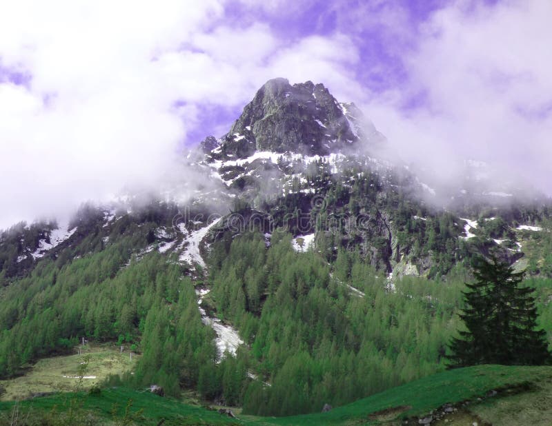 Un picco delle alpi svizzere circondate da nebbia fotografia stock Un picco delle alpi svizzere circondate da nebbia fotografia stock