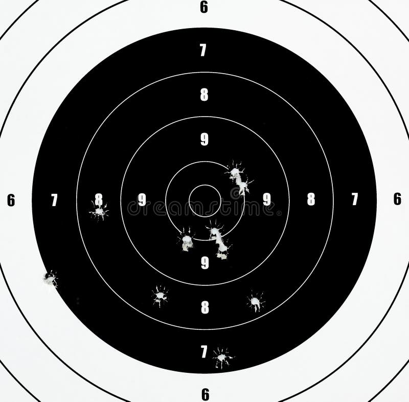 A Closeup of a practice target used for shooting with bullet holes in it. A Closeup of a practice target used for shooting with bullet holes in it.