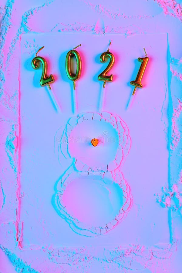 New Year`s concept, a snowman made of flour with a carrot nom and hands matches, in neon light. New Year`s concept, a snowman made of flour with a carrot nom and hands matches, in neon light.