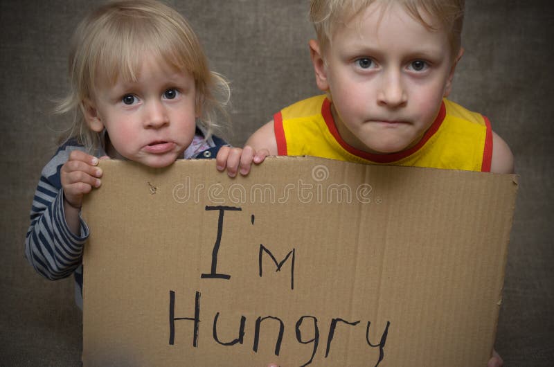 Un ragazzo affamato e una ragazza con una compressa del cartone con il ` m. dell'iscrizione I affamato Il problema sociale