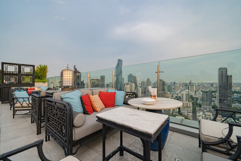 Un ristorante o una terrazza di bar con tavola sul tetto dell'hotel, un edificio ad alta ascesa con vista in città fotografie stock