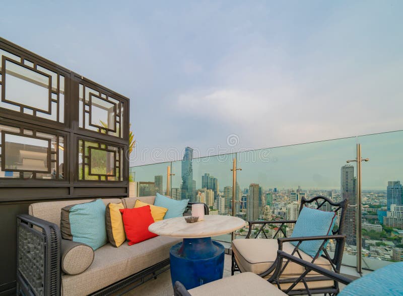 Un ristorante o una terrazza di bar con tavola sul tetto dell'hotel, un edificio ad alta ascesa con vista in città fotografia stock libera da diritti