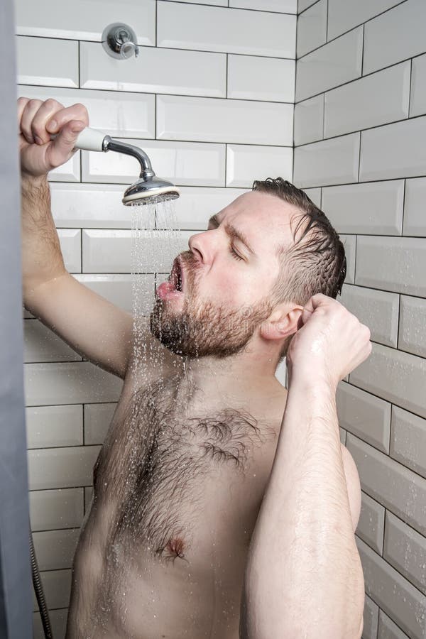 Strange, funny bearded man enthusiastically sings in the bathroom, using a shower with running water instead of a microphone. Hobbies and leisure. Lifestyle. Strange, funny bearded man enthusiastically sings in the bathroom, using a shower with running water instead of a microphone. Hobbies and leisure. Lifestyle.