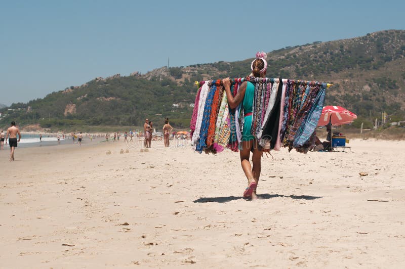 Un venditore ambulante della donna con scialli su una spiaggia spagnola a Tarifa immagini stock libere da diritti Un venditore ambulante della donna con scialli su una spiaggia spagnola a Tarifa immagini stock libere da diritti
