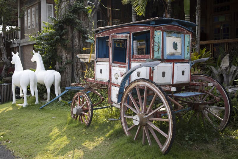 Image of an old painted horse-drawn coach style wooden carriage. Image of an old painted horse-drawn coach style wooden carriage