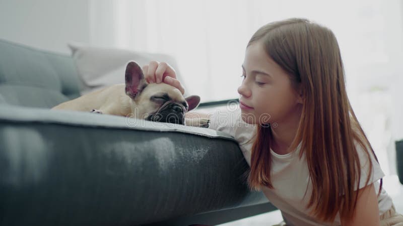 Una adolescente guapa a su perro somnoliento.