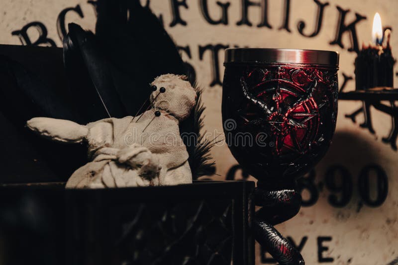 A handmade voodoo doll with pins, set against a rustic backdrop, evoking occult practices. A handmade voodoo doll with pins, set against a rustic backdrop, evoking occult practices