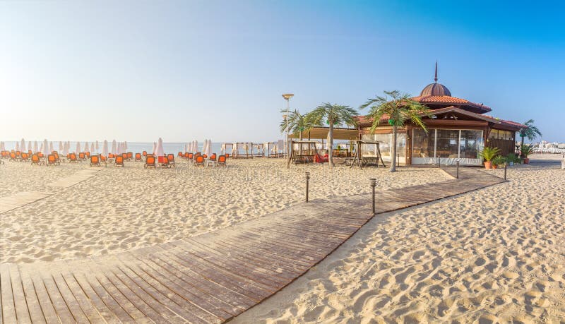 Una barra en la playa con las sillas y los paraguas en una playa hermosa en la salida del sol en Sunny Beach en la costa del Mar fotos de archivo libres de regalías Una barra en la playa con las sillas y los paraguas en una playa hermosa en la salida del sol en Sunny Beach en la costa del Mar fotos de archivo libres de regalías