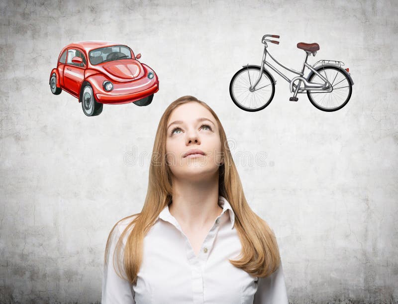 Una bella donna sta provando ha scelto il modo più adatto per il viaggio o permutare Due schizzi di un'automobile e di una bicicletta sono attinti il muro di cemento