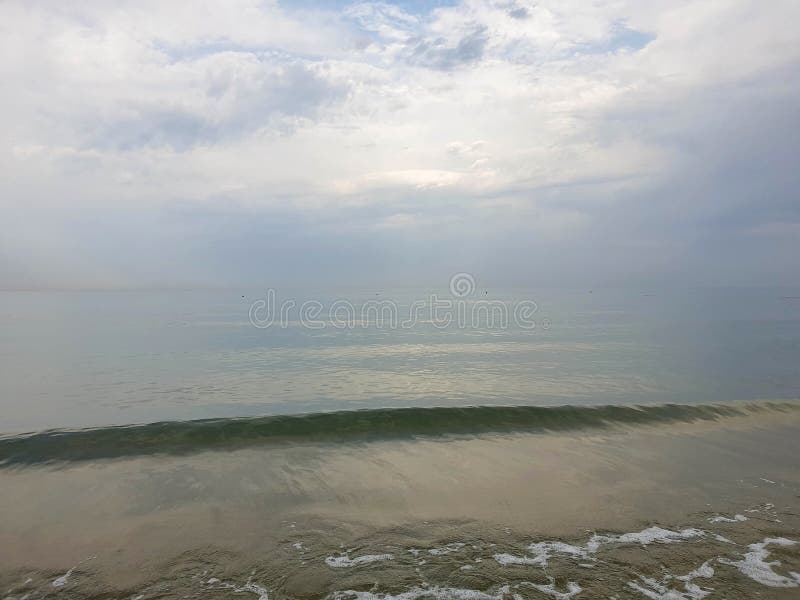 A warm summer morning on the coast of the Black sea. Anapa, Krasnodar region. Calm sea, sunrise. A warm summer morning on the coast of the Black sea. Anapa, Krasnodar region. Calm sea, sunrise