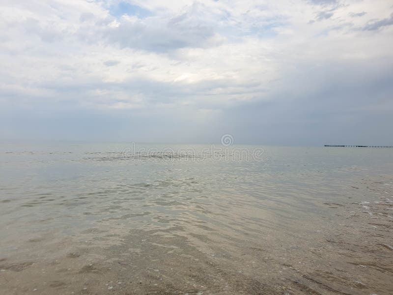 A warm summer morning on the coast of the Black sea. Anapa, Krasnodar region. Calm sea, sunrise. A warm summer morning on the coast of the Black sea. Anapa, Krasnodar region. Calm sea, sunrise