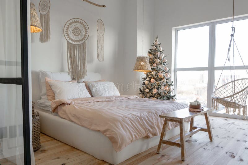 Una camera da letto bianca decorata con un albero di Natale fotografie stock