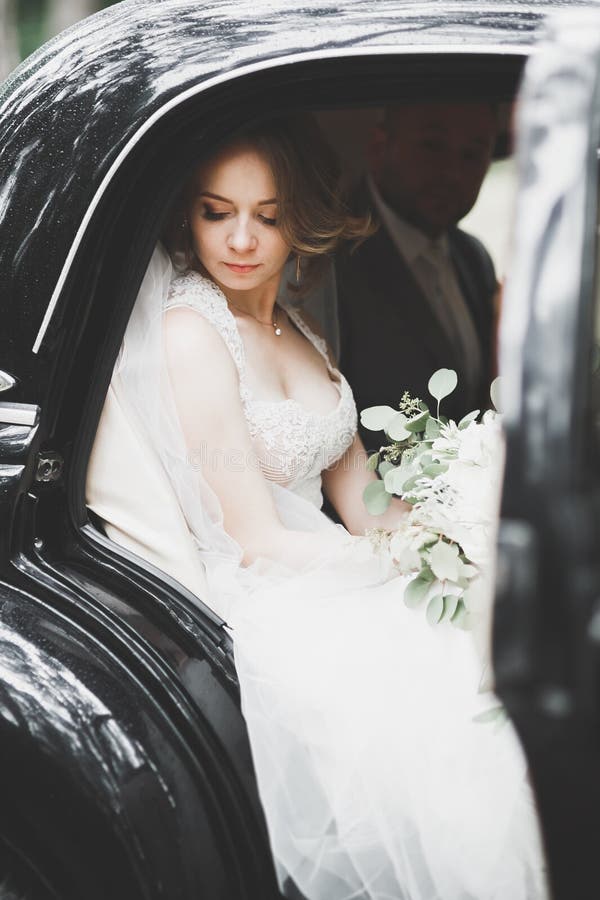 Just married couple in the luxury retro car on their wedding day. Just married couple in the luxury retro car on their wedding day.