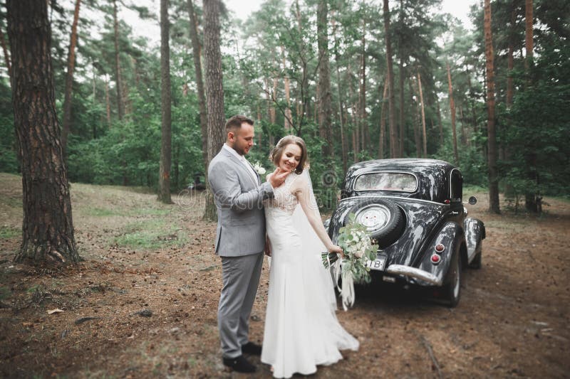 Just married couple in the luxury retro car on their wedding day. Just married couple in the luxury retro car on their wedding day.