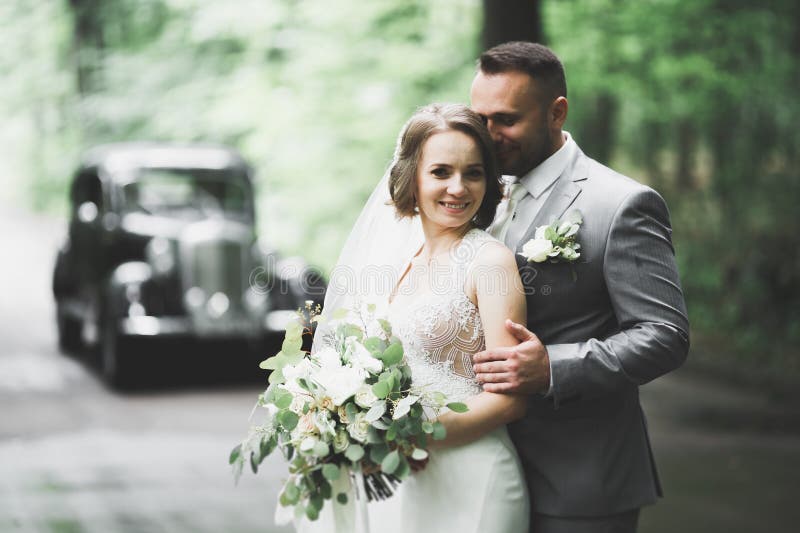 Just married couple in the luxury retro car on their wedding day. Just married couple in the luxury retro car on their wedding day.