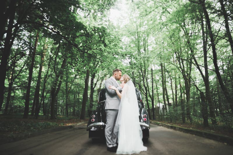 Just married couple in the luxury retro car on their wedding day. Just married couple in the luxury retro car on their wedding day.