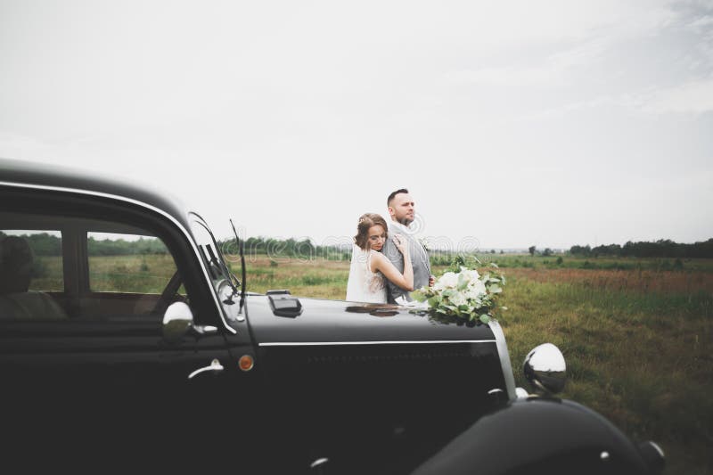 Just married couple in the luxury retro car on their wedding day. Just married couple in the luxury retro car on their wedding day.