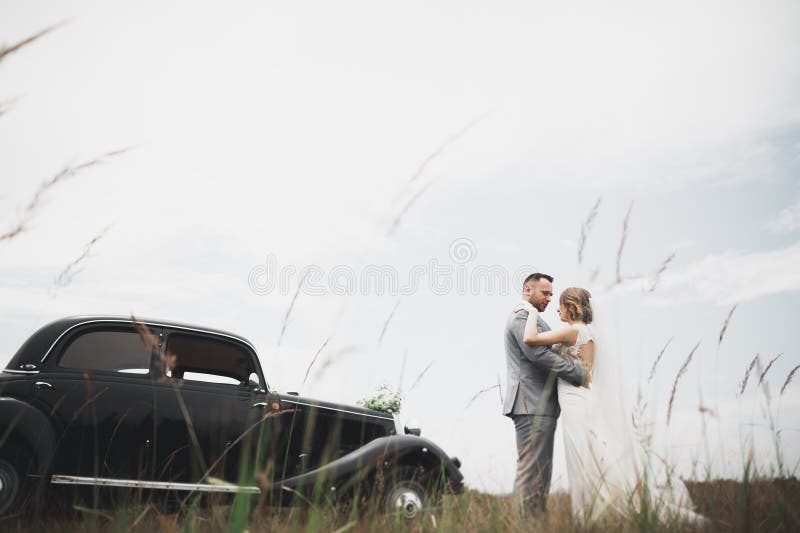 Just married couple in the luxury retro car on their wedding day. Just married couple in the luxury retro car on their wedding day.