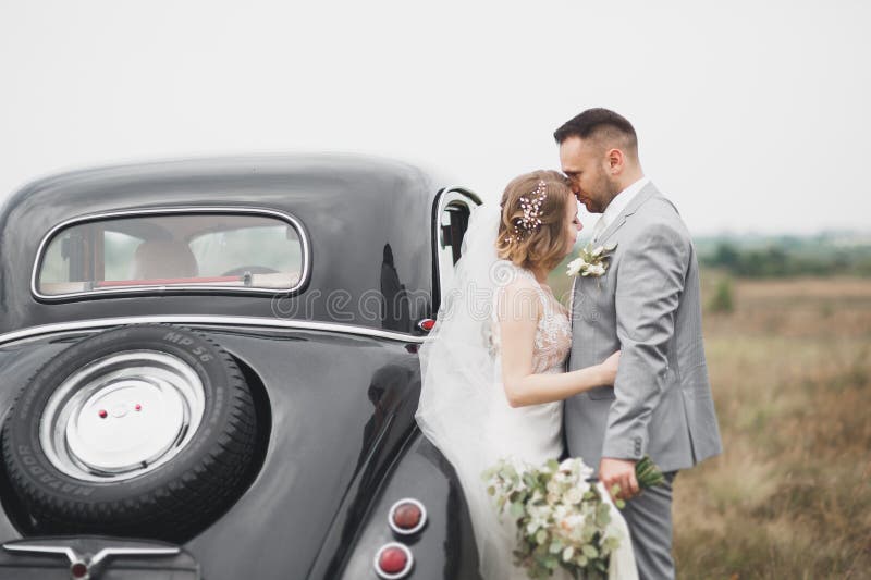 Just married couple in the luxury retro car on their wedding day. Just married couple in the luxury retro car on their wedding day.