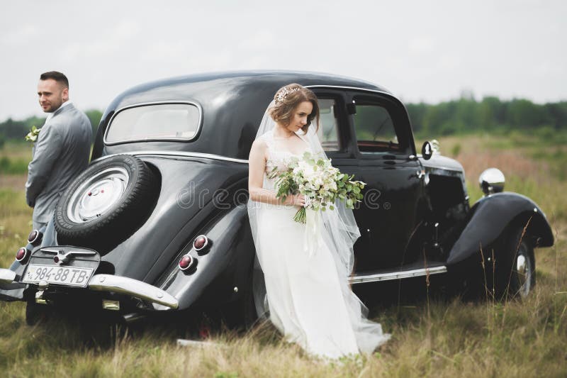 Just married couple in the luxury retro car on their wedding day. Just married couple in the luxury retro car on their wedding day.