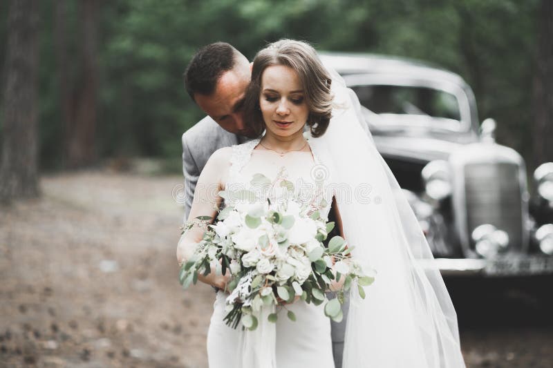 Just married couple in the luxury retro car on their wedding day. Just married couple in the luxury retro car on their wedding day.