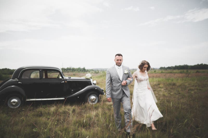 Just married couple in the luxury retro car on their wedding day. Just married couple in the luxury retro car on their wedding day.