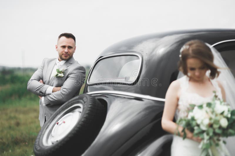 Just married couple in the luxury retro car on their wedding day. Just married couple in the luxury retro car on their wedding day.