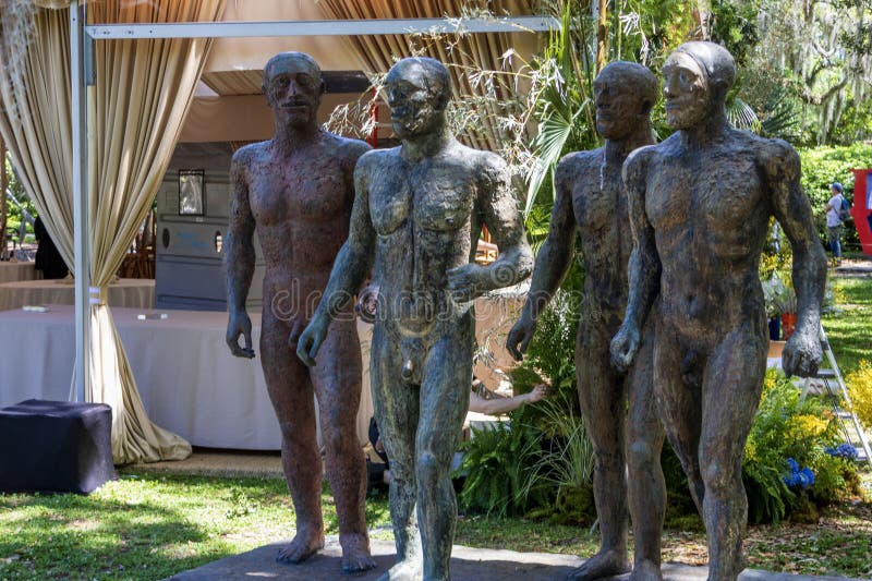 A sculpture called Rebus, 3D-89-3 by Ida Kohlmeyer with lush green trees, grass and plants and blue sky in Sculpture Garden at New Orleans City Park in New Orleans Louisiana USA. A sculpture called Rebus, 3D-89-3 by Ida Kohlmeyer with lush green trees, grass and plants and blue sky in Sculpture Garden at New Orleans City Park in New Orleans Louisiana USA