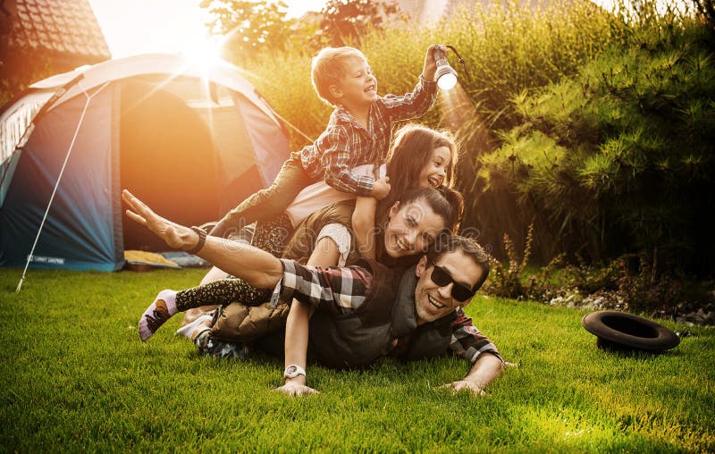 Cheerful family realxing on a summer camp. Cheerful family realxing on a summer camp