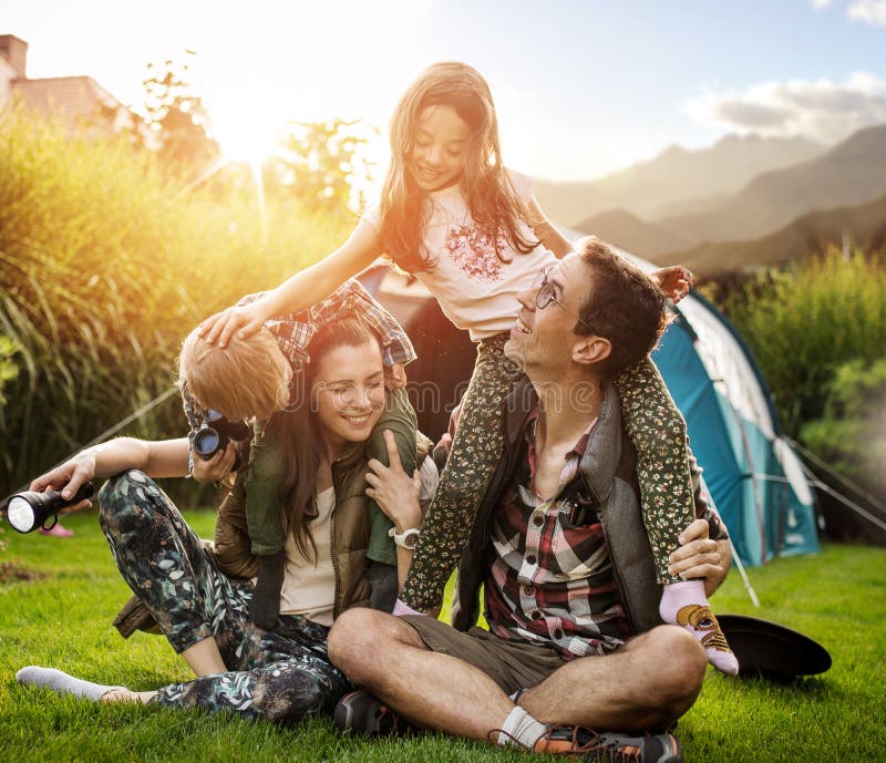 Cheerful family realxing on a summer camp. Cheerful family realxing on a summer camp