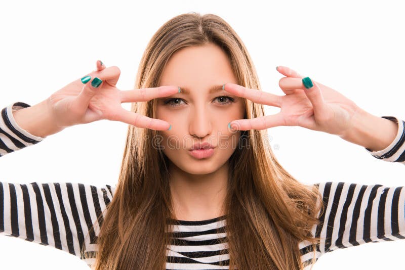 Sexy young woman looks through two signs of peace. Sexy young woman looks through two signs of peace.