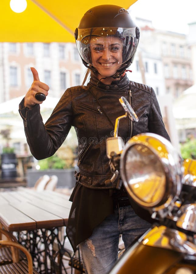 Una mujer en un casco negro del moto imagen de archivo libre de regalías Una mujer en un casco negro del moto imagen de archivo libre de regalías