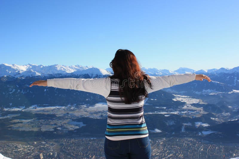 A beautiful young woman experiencing freedom. Mountain Range Innsbruck, Austria. Woman with her arms open. A beautiful young woman experiencing freedom. Mountain Range Innsbruck, Austria. Woman with her arms open.