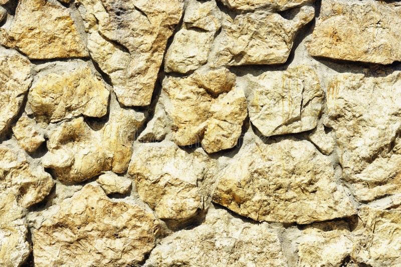 Una parete strutturata fatta della pietra naturale fotografie stock Una parete strutturata fatta della pietra naturale fotografie stock