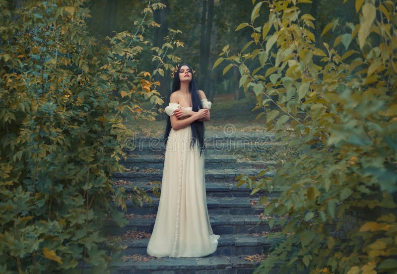 A princess with sexually bare shoulders enjoys a moment of silence and loneliness. Black long hair, golden wreath, cream silk vintage dress. runaway Bride. A princess with sexually bare shoulders enjoys a moment of silence and loneliness. Black long hair, golden wreath, cream silk vintage dress. runaway Bride.