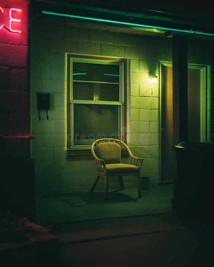 A chair outside a motel with neon colors, Winslow, Arizona. A chair outside a motel with neon colors, Winslow, Arizona.
