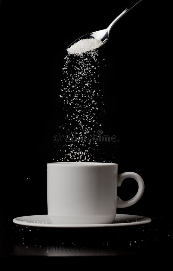 Sugarfall. A cup of coffee with sugar flow and spoon. Concept of addiction to sugar. Black and white photo. Sugarfall. A cup of coffee with sugar flow and spoon. Concept of addiction to sugar. Black and white photo.