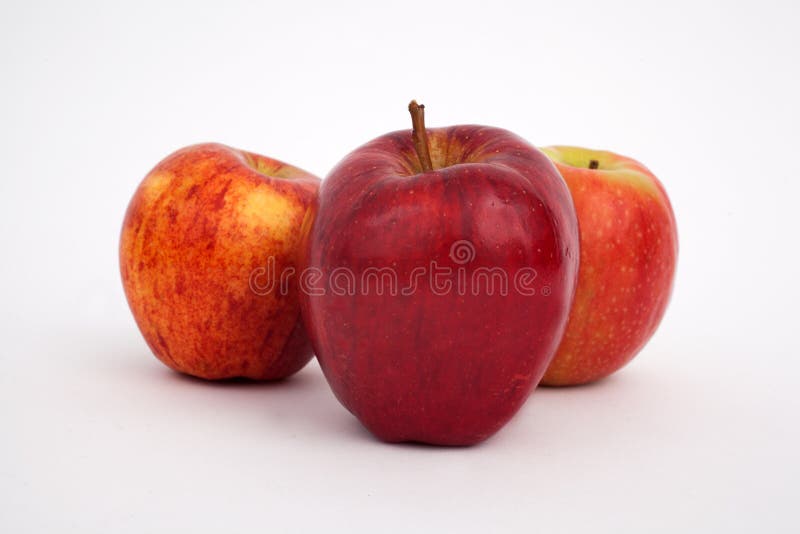 A studio image of 3 red apples photographed against a white background. A studio image of 3 red apples photographed against a white background
